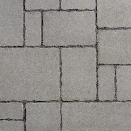 Oregelbundet mönster av fyrkantiga och rektangulära plattor i olika storlekar och nyanser av grått.