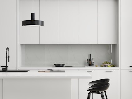 Modernt kök i vitt med svarta detaljer, inklusive lampor, stolar och blandare. Marbleffekt på väggens bakgrund.