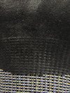 Svart och grått texturerat material med randigt mönster i nederkanten.