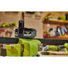 18V Ryobi Lithium+ batteri inställt i ett skruvstäd på en verkstadsbänk. Bakgrund med verktyg.
