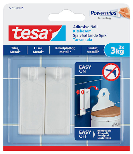 Förpackning för Tesa självhäftande spik, 2 stycken, 3 kg kapacitet, med instruktioner och märken för kakel och metall.