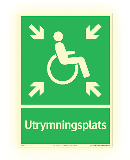 Grön skylt med rullstolssymbol och fyra pilar pekande mot mitten. Texten "Utrymningsplats" längst ner.