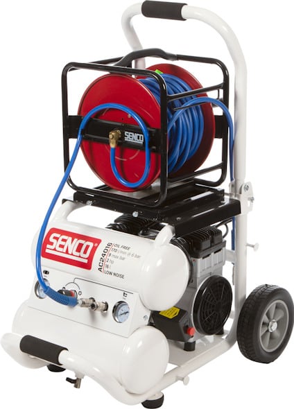 Luftkompressor på vagn med slangvinda och blå slang, märkt "SENCO".