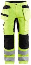 Arbetsbyxor i neon-gul och svart med reflexband på benen och flera fickor.
