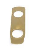 Guldfärgad rektangulär platta med två hål, ett större och ett mindre.