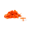 Orange plastdistanser i T-korsform, staplade och spridda på ett vitt underlag.