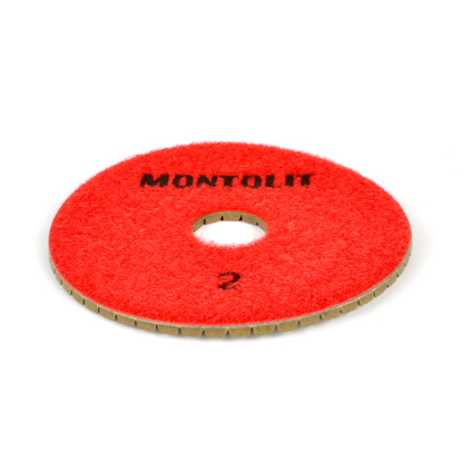 Röd polerpad med hål i mitten och texten "MONTOLIT" och siffran "2" på ytan.