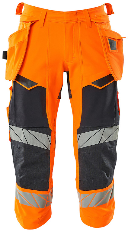 Arbetsbyxa i hi-vis orange med mörkblå detaljer och reflexband på benen. Flera fickor och verktygshållare.