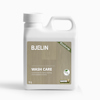 Plastdunk med texten "BJELIN WASH CARE". Dunken är vit med en grön etikett och innehåller 1 liter.