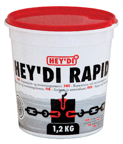 Vit hink med röd lock, märkt "HEY'DI RAPID". Text på flera språk och illustration med kedja och svart block.