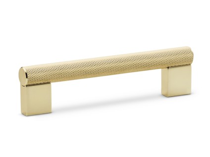 Ett guldfärgat lådhandtag med ett cylinderformat grepp och rektangulära fästen.