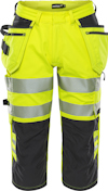 Varselbyxor i gult och svart med reflexband runt benen. Flera fickor är synliga framtill.