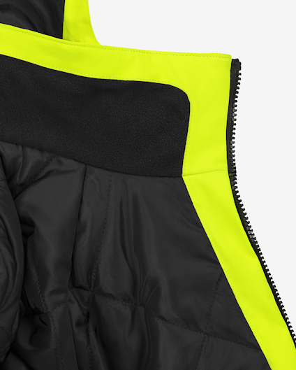 Svart och neongul jacka med dragkedja, insida av fleece och quiltad design.