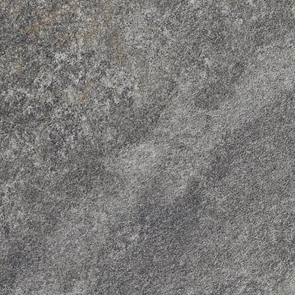 Grå stenliknande yta med ojämn textur och marmorering i mörkare och ljusare nyanser.