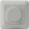 Väggmonterad dimmer i ljus färg med en rund justeringsknapp i mitten.