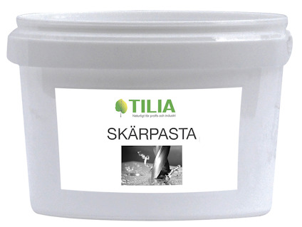 Vit plastburk med etiketten "Tilia SKÄRPASTA" och en bild av en slipprocess.