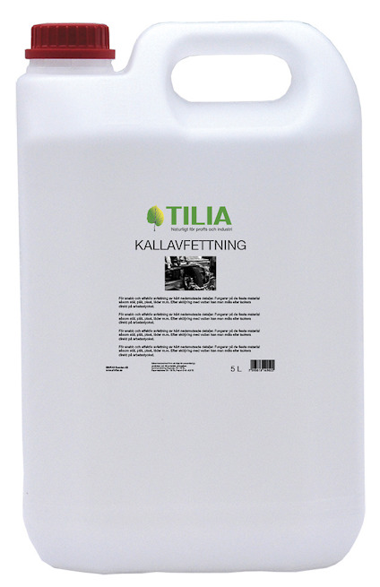 Vit plastdunk med röd kork, etikett märkt "TILIA KALLAVFETTNING".