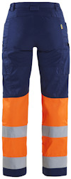 Mörkblå och orange byxor med reflexband på benen, bakifrån.
