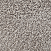 Beige och brunt tuftat textilgolv med mjuka fibrer och ojämn textur.