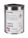 Rund metallburk med etikett som visar texten "KARBID" och varningssymbol för brandfarliga gaser.