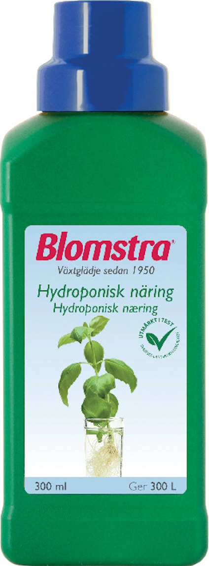 Grön flaska med etikett där det står "Blomstra", "Hydroponisk näring" och en bild på en växt med rötter i vatten.