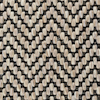 Beige och svart zigzagmönstrat textilgolv i fiskbensmönster.