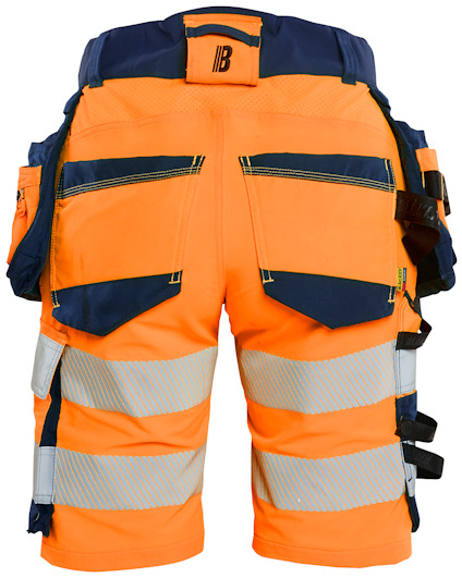 Orange och blå arbetsbyxor med reflexband och flera fickor, sedd bakifrån.