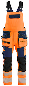 Orange och marinblå hängselbyxa med flera fickor och justerbara remmar.