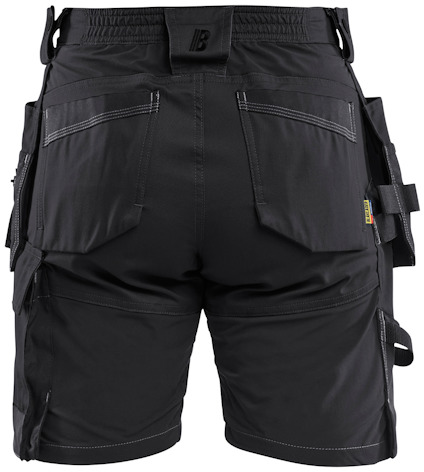 Svarta arbetsshorts med flera fickor och förstärkta sömmar, set bakifrån.