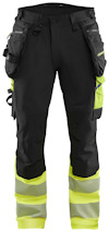 Svarta arbetsbyxor med gula kontrastdetaljer och förstärkta knäskydd samt reflexband längst ner på benen.