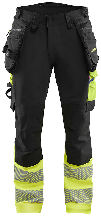 Svarta arbetsbyxor med gula kontrastdetaljer och förstärkta knäskydd samt reflexband längst ner på benen.
