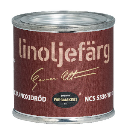Burk med mörkröd etikett märkt "linoljefärg järnoxidröd".