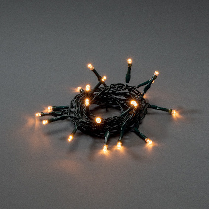 Ljusslinga med 10 amber LED-lampor på mörk kabel, slingrad i en cirkel, mot grå bakgrund.