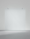 Transparent glass panel against a plain gray background, supported by small metal brackets at the top.