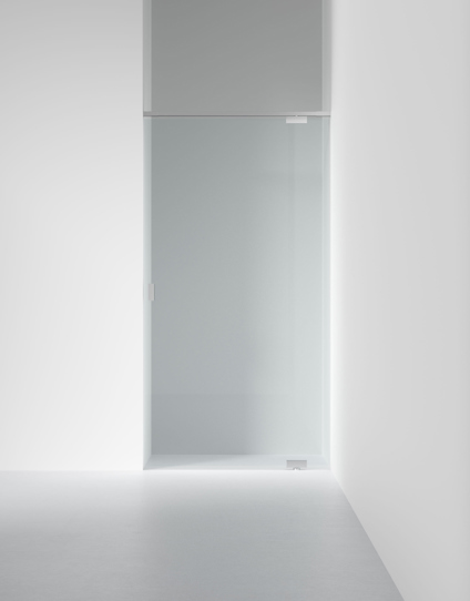 Glasdörr monterad i en minimalistisk, vit vägg med en ljusgrå golvyta.