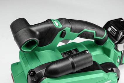Grön och svart handhållen elektrisk verktygsenhet med ett grepphandtag och batteri.