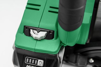 Grön och svart elektrisk enhet med ett justerbart reglage och texten "12".