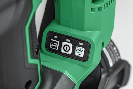 Grön och svart verktyg med tre knappar med symboler på handtaget.